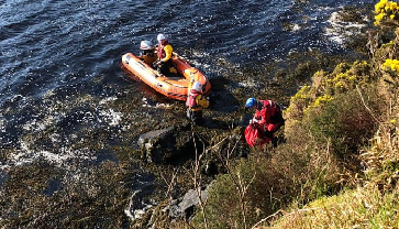 Dog rescued from rocks